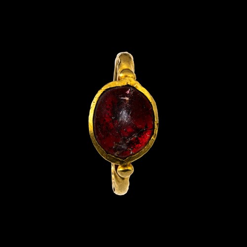 A Roman gold ring set with a large cabochon garnet.
